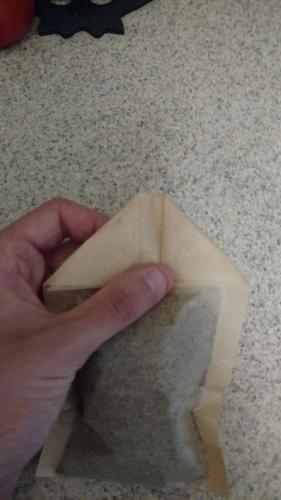 Tea bag with corners folded down.